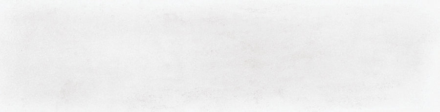 The Harmony 2.5x10 Porcelain Tile features a blank white textured surface with subtle grey specks and slight shading variations, resembling lightly marbled or gently worn handmade tile.