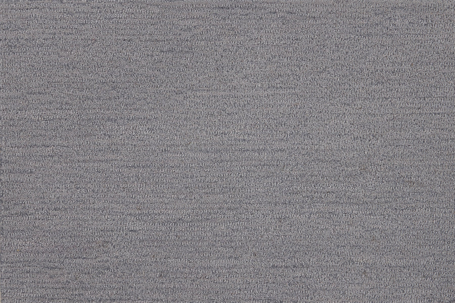 Close-up view of Highlands Berber Carpet in Big Sky color, featuring a textured grey fabric with subtle heathered pattern and fine horizontal lines—perfect for contemporary flooring that’s both stylish and durable.