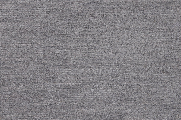 Close-up view of Highlands Berber Carpet in Big Sky color, featuring a textured grey fabric with subtle heathered pattern and fine horizontal lines—perfect for contemporary flooring that’s both stylish and durable.