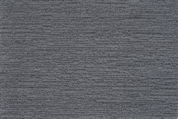 Close-up of Highlands Berber Carpet in Mineral—a textured dark gray carpet with subtle horizontal lines and a slightly mottled pattern, providing contemporary, comfortable flooring.