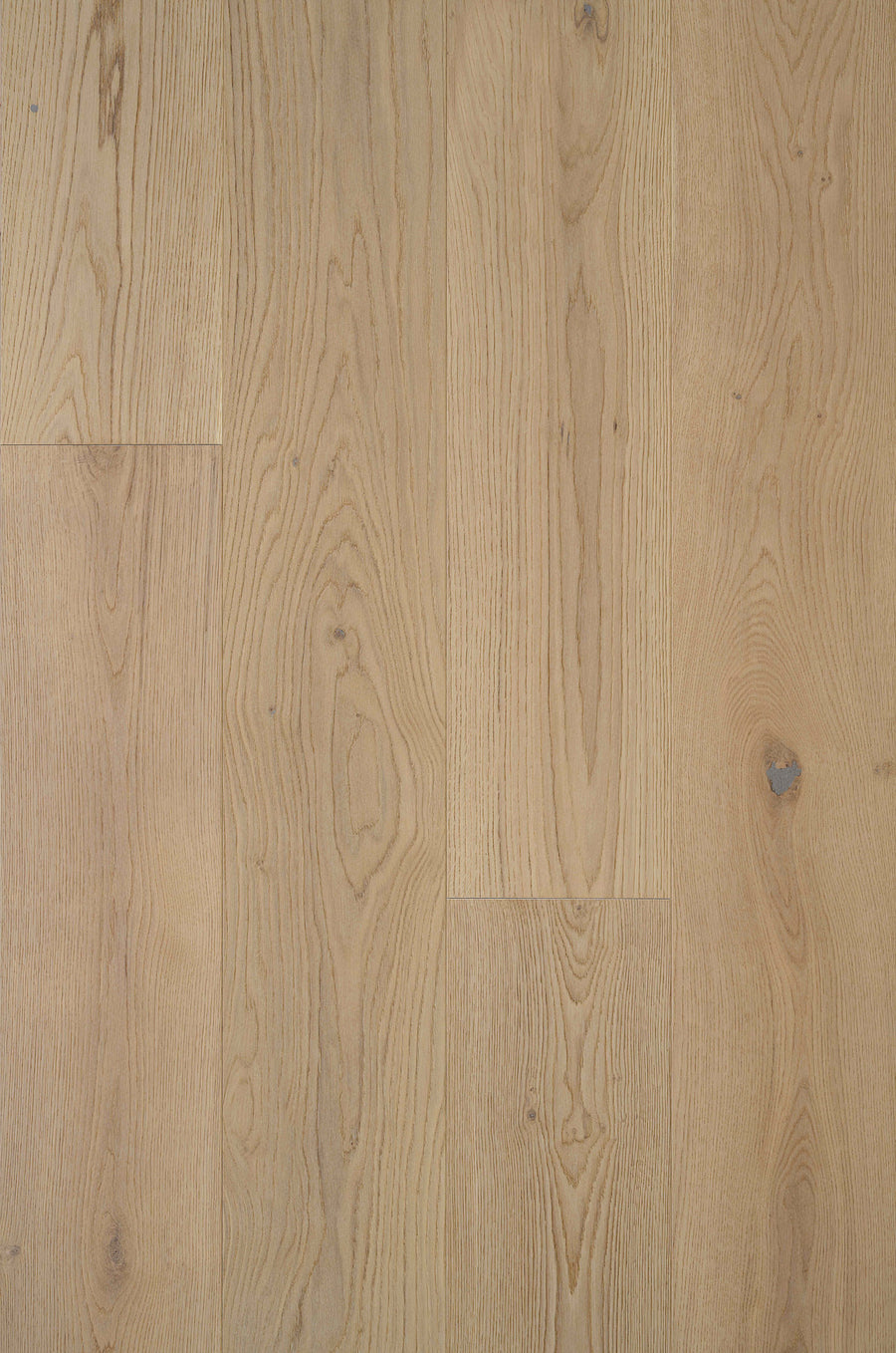 Tribeca Loft French Oak 9.4" Hardwood in Hamilton features light brown wide planks with visible natural grain patterns and knots, highlighting subtle variations in color and texture for an authentic wood floor look.