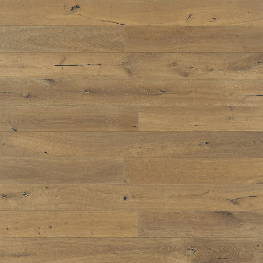 Provincetown 7 1/2" White Oak Hardwood features light brown wide planks with visible grain, natural knots, and subtle color variations, creating a rustic and warm look.