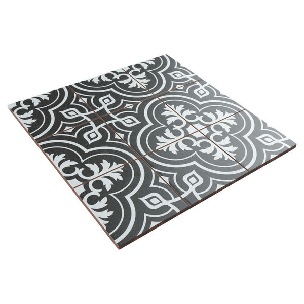 A set of nine black and white ceramic tiles arranged in a square, featuring an ornate, symmetrical floral and geometric pattern.