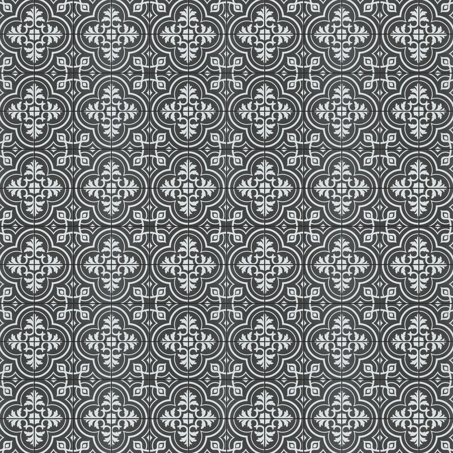 A repeating black and white tile pattern featuring ornate, symmetrical floral and geometric designs, resembling traditional vintage or Moroccan-style motifs.