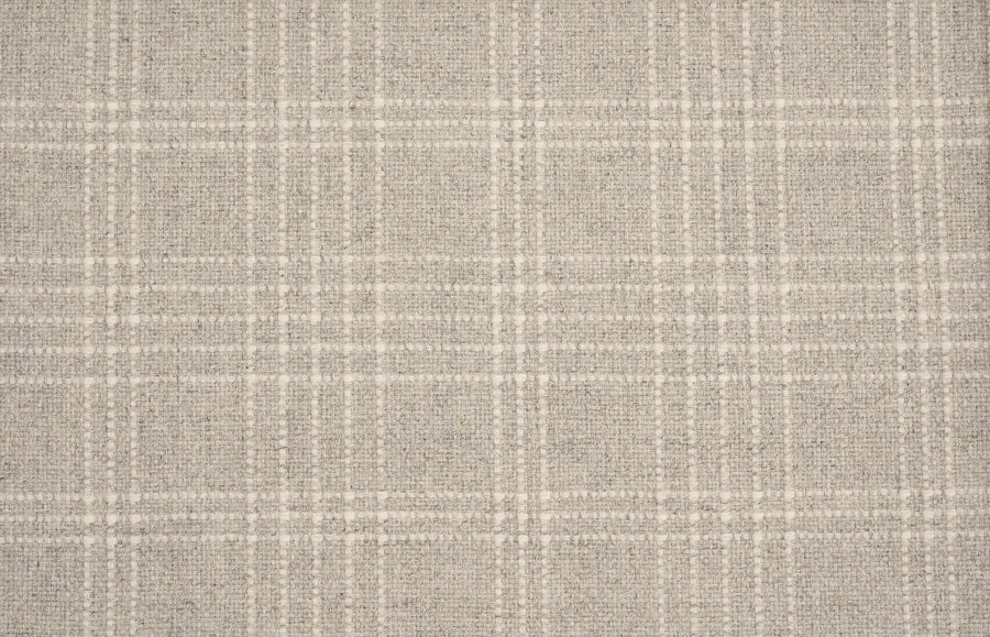 A close-up of the Pristine Plaid Berber Carpet in Heather shows its beige and off-white grid pattern, ideal for adding sophisticated style and durability to any space.
