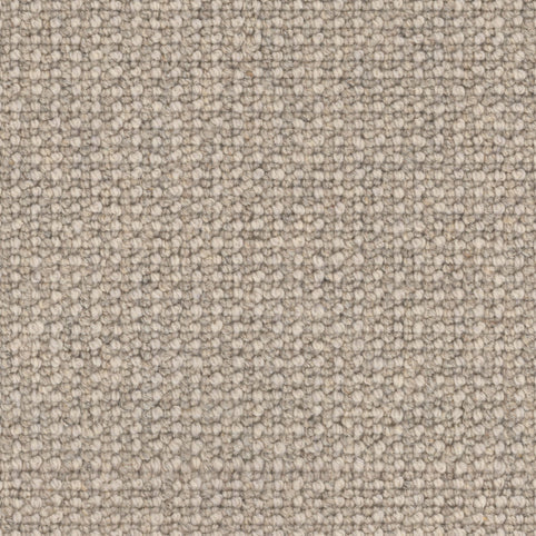 Close-up of the Andros Berber Carpet in Heirloom color, featuring a tightly woven, looped pile with small, evenly spaced loops in shades of beige and light brown for a soft, uniform look.