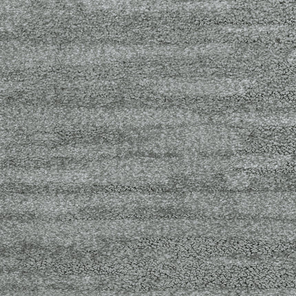 Close-up view of the Cirrus Berber Carpet in Heron—this gray textured luxury carpet features soft, subtle shading and a plush, even surface, making it an elegant choice for premium flooring.