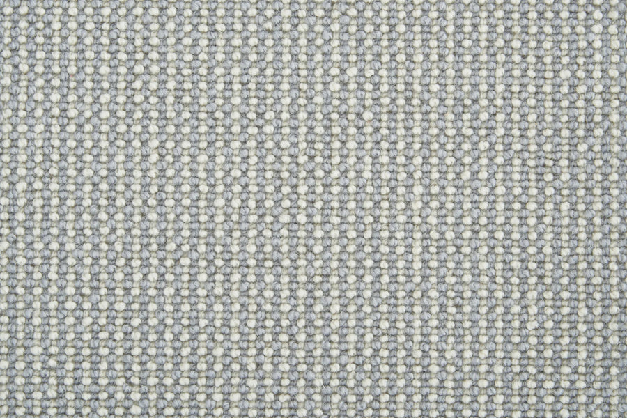 Close-up of Harper Berber Carpet in Ice, showing a textured woven pattern with tightly packed cream and light gray threads for a subtle grid-like design that offers timeless style and everyday durability.