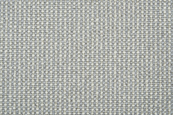 Close-up of Harper Berber Carpet in Ice, showing a textured woven pattern with tightly packed cream and light gray threads for a subtle grid-like design that offers timeless style and everyday durability.