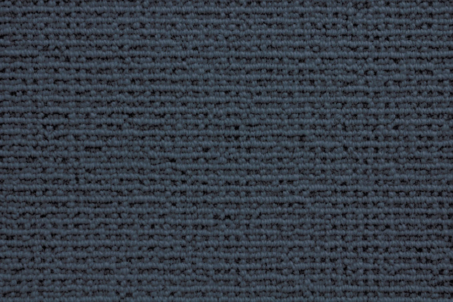 Close-up of the Sequoia Berber Carpet in Indigo, featuring a tightly woven, horizontal striped texture. Made from premium fibers, it offers a soft, uniform look that's perfect for high-traffic areas.