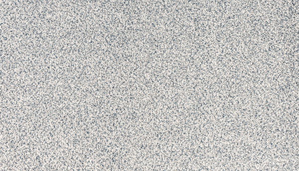Close-up of the Brocade color of Innovative Comfort I Pet Friendly Carpet, showing a textured surface with small, densely packed gray and white speckled dots for a luxurious, grainy look that's also great for pets.
