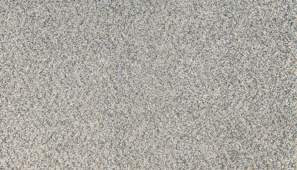 A close-up of Innovative Comfort I Pet Friendly Carpet in Meteor shows a textured surface with fine gray and beige tones, creating a natural speckled pattern reminiscent of luxury.