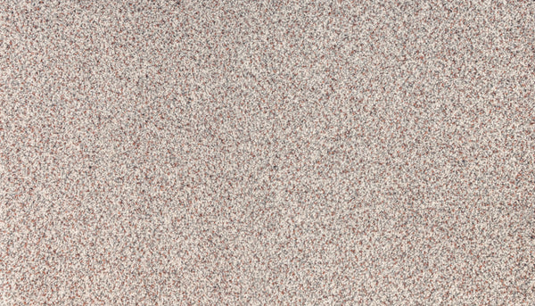 A close-up of Innovative Comfort III Pet Friendly Carpet in Crossette shows its dense, speckled surface with fine reddish-brown, gray, and white particles, creating a stain-resistant look ideal for pet-friendly homes.