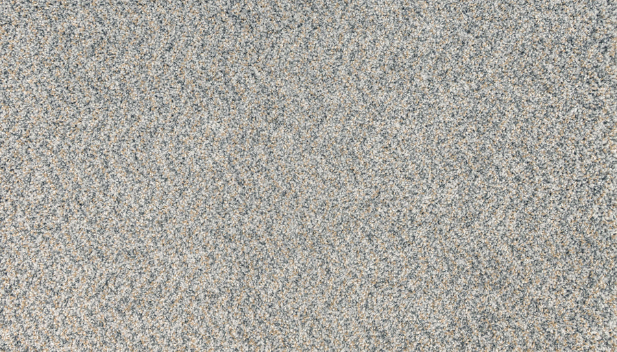 Close-up view of fine, multicolored grains—mostly gray with brown and off-white specks—resembling the textured pattern of Innovative Comfort II Pet Friendly Carpet in Meteor.