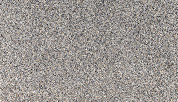 A close-up of the Innovative Comfort III Pet Friendly Carpet in Salute shows its textured, speckled gray surface—ideal for luxury spaces needing style, durability, and stain resistance.
