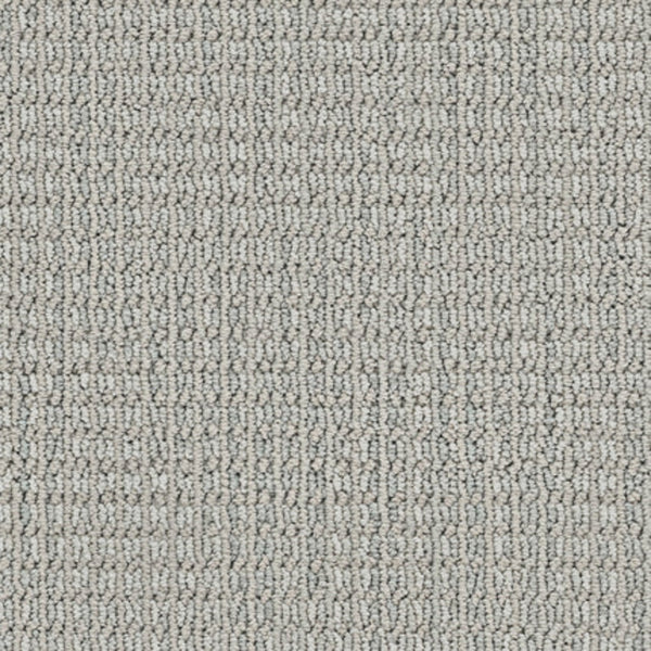 Close-up of Haven Berber Carpet in Intuitive, featuring a light gray color and looped pile with a subtle linear pattern. The tightly woven texture offers style and durability for any space.