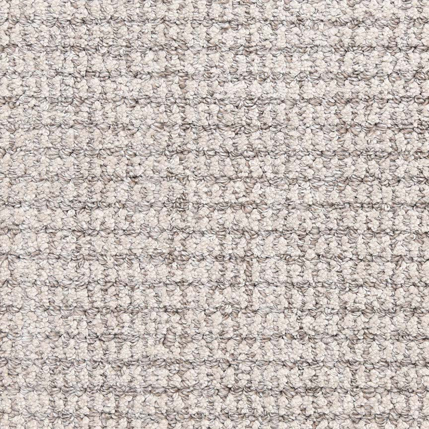 Close-up of Aspen Berber Carpet in Iron color, featuring a grid-like woven, loop-pile texture. Its dense, uniform fibers provide a soft and durable surface—perfect for those seeking a stylish, neutral backdrop.
