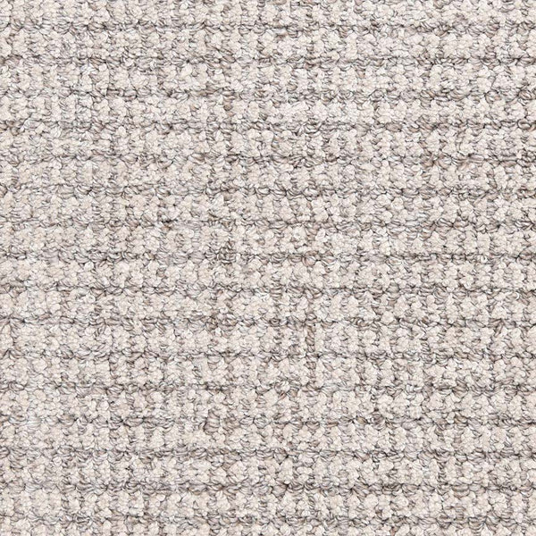 Close-up of Aspen Berber Carpet in Iron color, featuring a grid-like woven, loop-pile texture. Its dense, uniform fibers provide a soft and durable surface—perfect for those seeking a stylish, neutral backdrop.