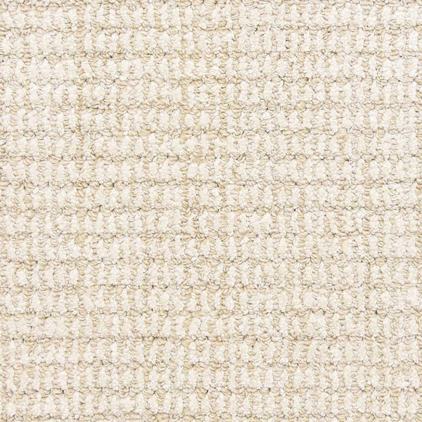 Close-up of the Aspen Berber Carpet in Ivory shows its tight, looped weave pattern for a grid-like look. The material appears soft, uniform, and highly durable.