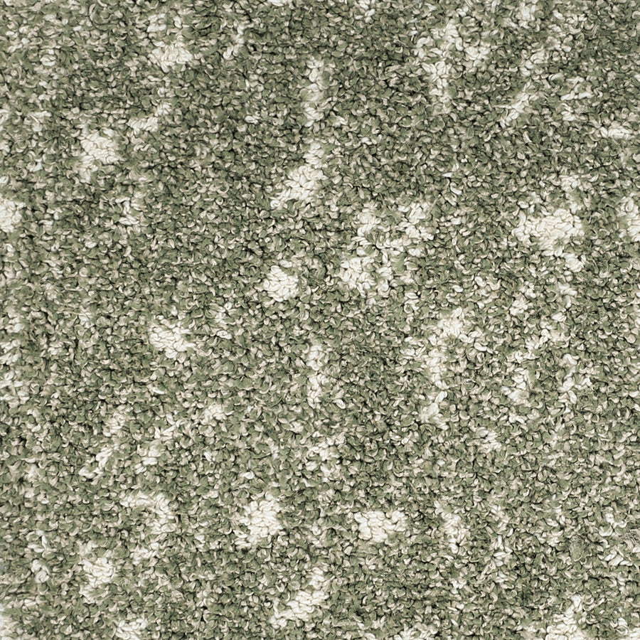 Close-up of Meow Mosaic Pet Friendly Carpet, showcasing green and white fibers in a mosaic pattern. The plush, soft pile is dense and slightly uneven, creating a cozy surface that’s ideal for pet-friendly spaces.