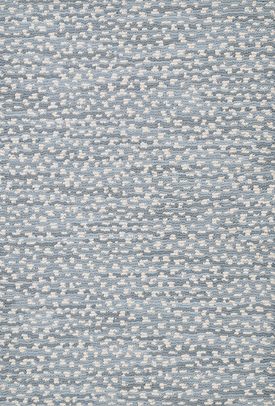 A close-up of Jag On Trend Carpet reveals its textured blue fabric, featuring small, evenly spaced white dots that create a speckled woven pattern with a touch of luxury.