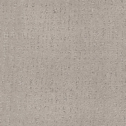 A close-up of Homage Berber Carpet in Jakarta shows its light beige textured fabric with a subtle, irregular dotted and stitched pattern, offering a soft, stylish look ideal for comfort and durability in high-traffic areas.