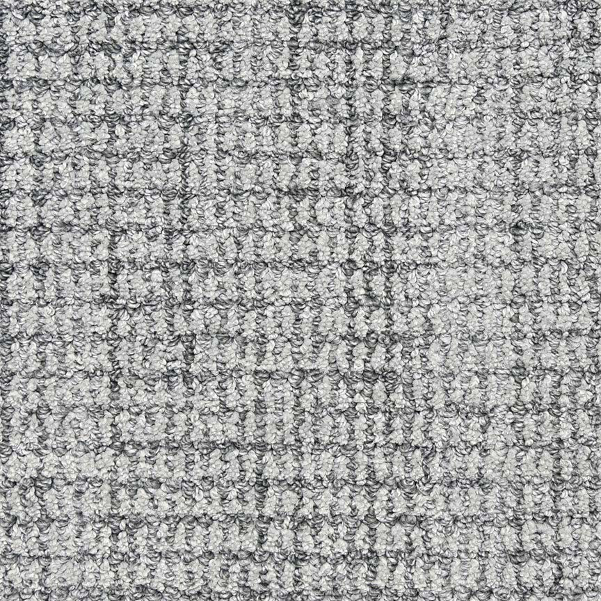 Close-up of Aspen Berber Carpet in Juniper, featuring a loop-pile texture and subtle checked pattern that showcases woven fibers and small loops for a durable, soft, grid-like surface.