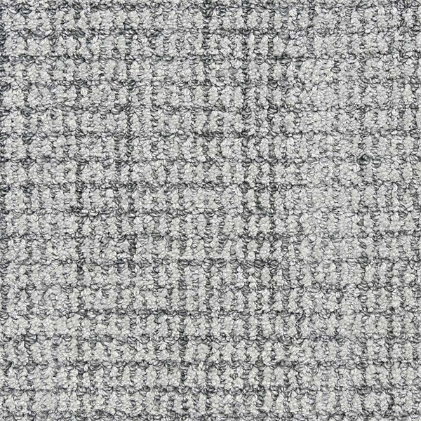 Close-up of Aspen Berber Carpet in Juniper, featuring a loop-pile texture and subtle checked pattern that showcases woven fibers and small loops for a durable, soft, grid-like surface.