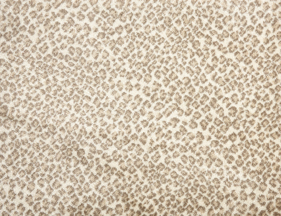 The Serengeti On Trend Carpet in khaki features a leopard-inspired pattern with small, irregular spots, creating a textured look that adds contemporary style to any space.