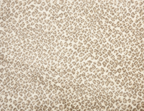 The Serengeti On Trend Carpet in khaki features a leopard-inspired pattern with small, irregular spots, creating a textured look that adds contemporary style to any space.