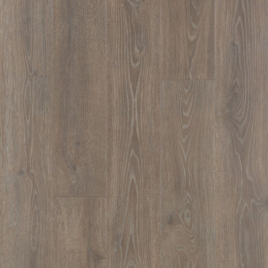 A close-up of Kindling Oak Antique Style 9 7/16" Waterproof Laminate flooring, showcasing rustic, textured planks with a natural wood grain pattern for an antique reclaimed wood look.