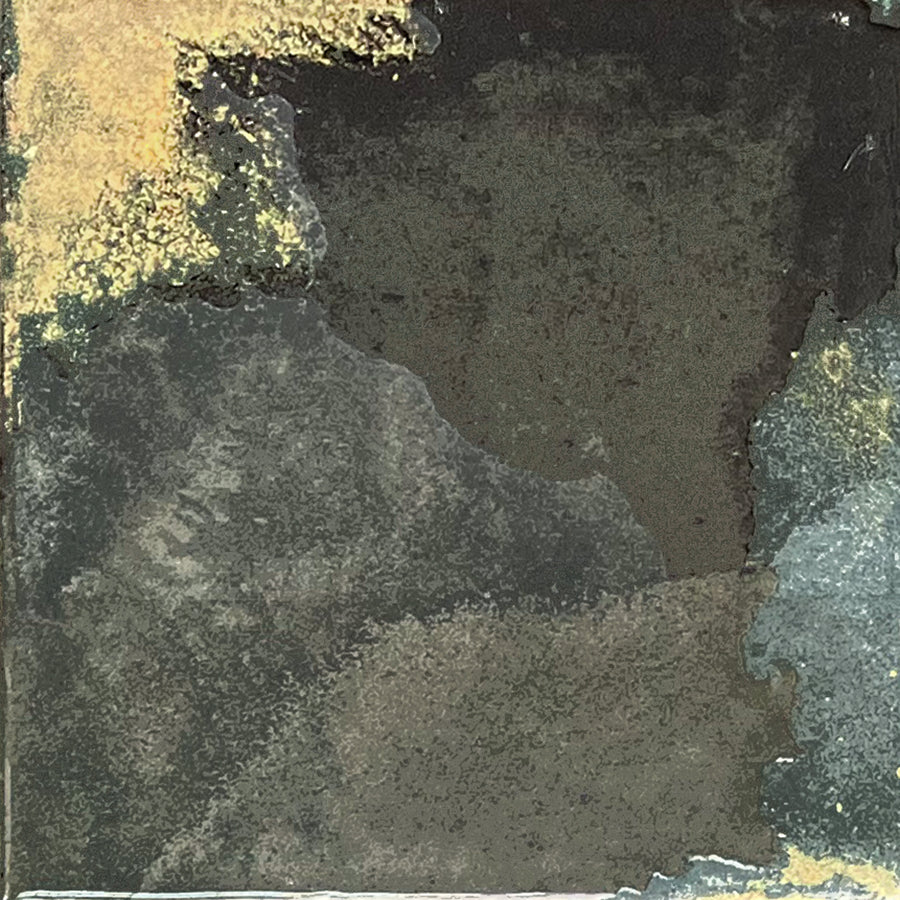 A close-up photo of the Kinetic 4.5x4.5 Porcelain Tile in Fluid Force, showcasing a weathered metal-inspired surface with textured, paint-like areas in shades of gold, black, and gray—evoking the tactile beauty reminiscent of glazed finishes and artisanal pottery.