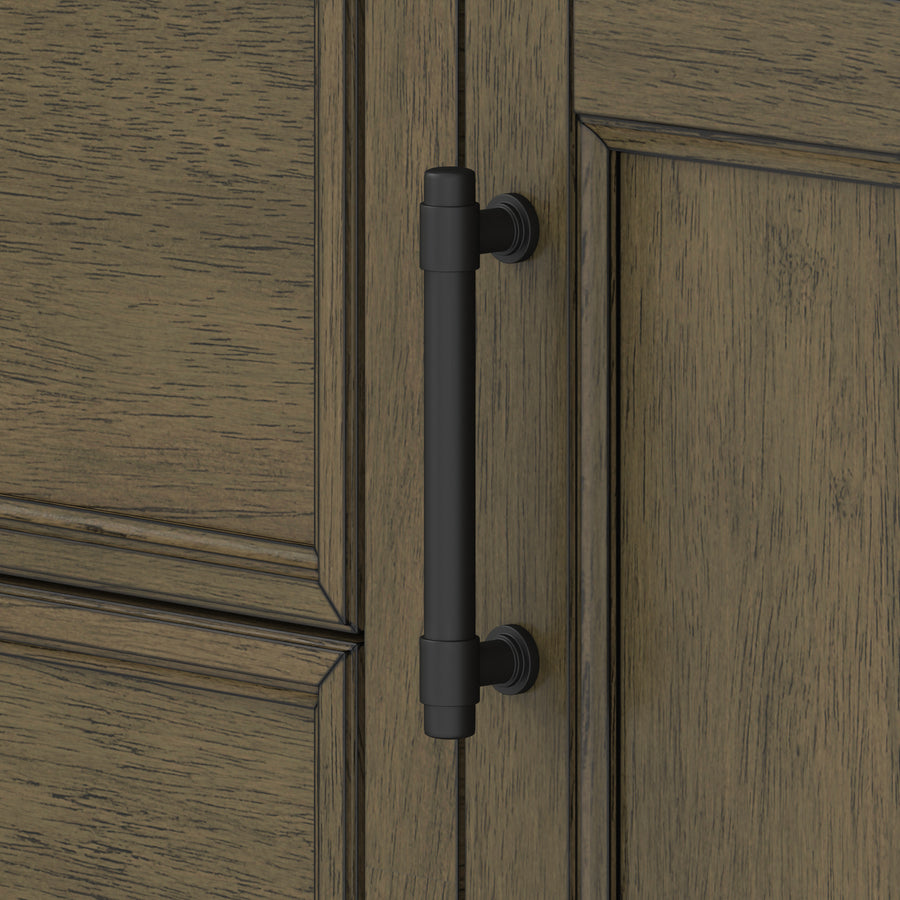 A close-up of a wooden cabinet door with a matte black vertical handle attached near the edge. The wood has a distressed, textured finish with visible grain patterns.