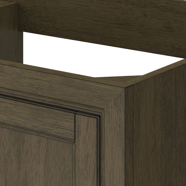 A close-up of a brown wooden cabinet with a rectangular cutout at the top, showing detailed wood grain and panel design on the front.