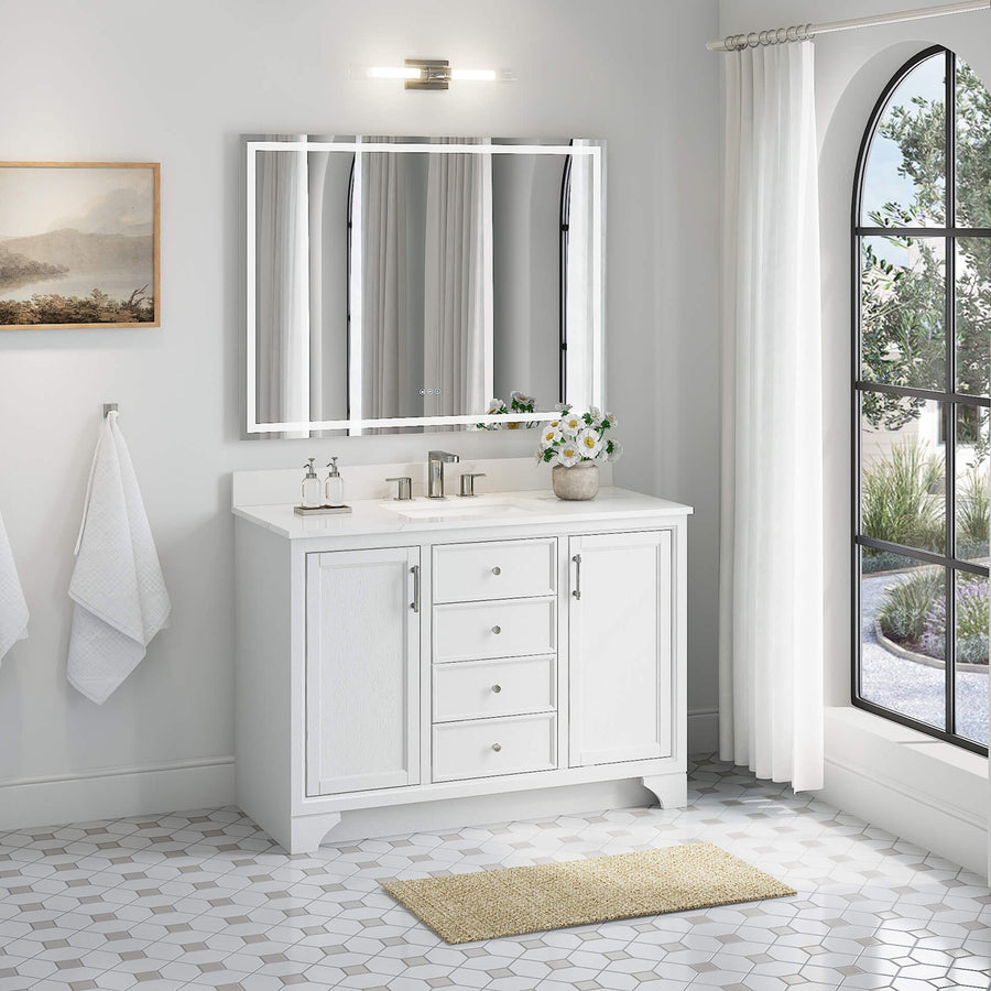 A bright, modern bathroom featuring the Lanagan 48" Vanity with double sink, large mirror, light fixture, wall towel rack, arched window with sheer curtains, and a beige rug on a hexagonal tile floor.