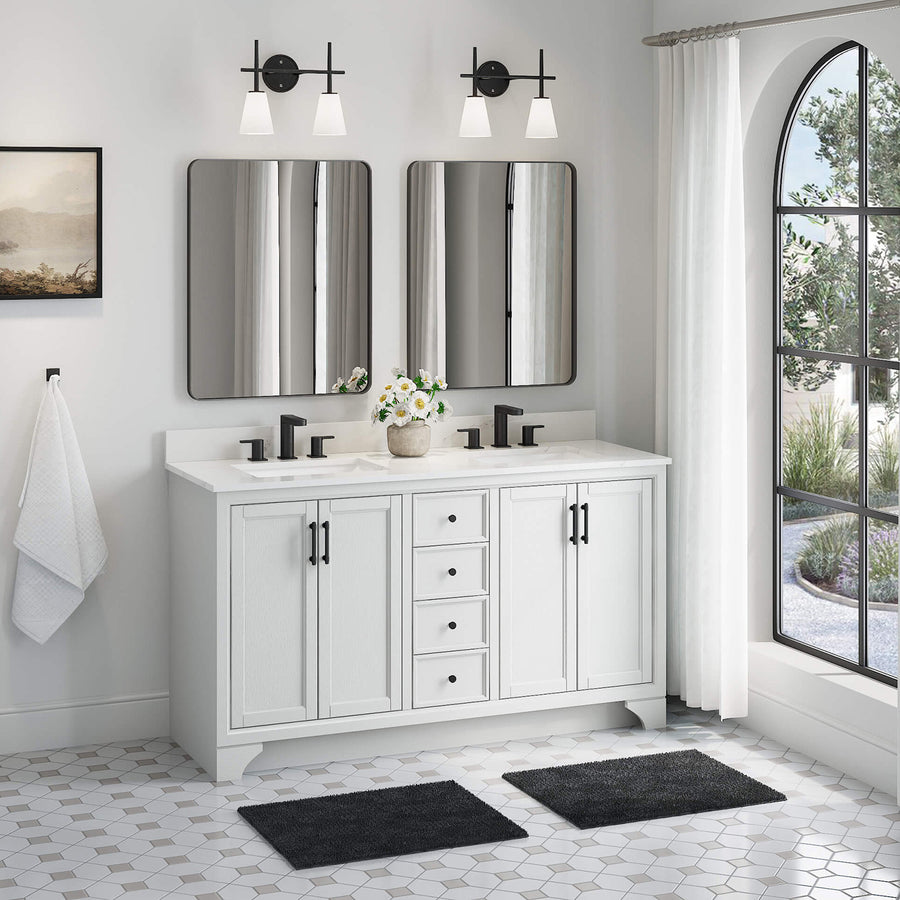 A modern bathroom features a white double-sink vanity with black fixtures, two mirrors, wall lamps, black mats, a towel on a hook, hexagonal floor tiles, and a large arched window with white curtains.