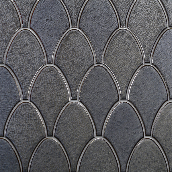 Close-up of Shinju Stingray Mosaic Tile in Cape Pearl, featuring a textured surface with overlapping, dark gray, fish scale-shaped tiles outlined by thin metallic lines for an intricate mosaic look.