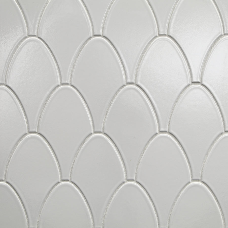 The Shinju Stingray Mosaic Tile in Kumamoto features white ceramic tiles with a repeating stingray pattern, slightly raised borders, and a glossy finish for elegant light reflection.