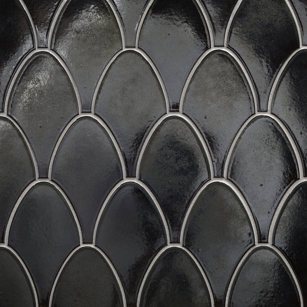 Close-up of Shinju Stringray Mosaic Tile in Olympia color, showing a dark, glossy fish scale design with smooth curved shapes, light grout outlines, and durable ceramic construction.