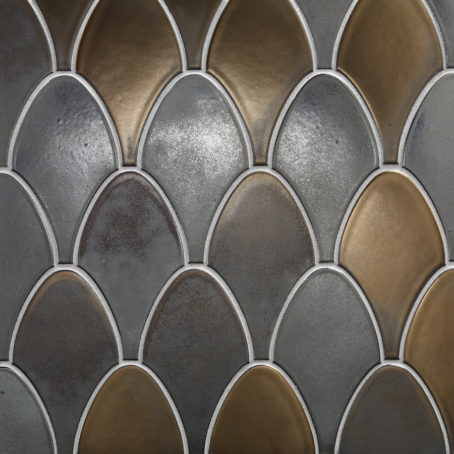 Close-up of Shinju Stingray Mosaic Tile in Pacific, featuring fish scale-like overlapping ceramic shapes in metallic gold, bronze, and silver tones with white outlines for a textured, reflective finish.