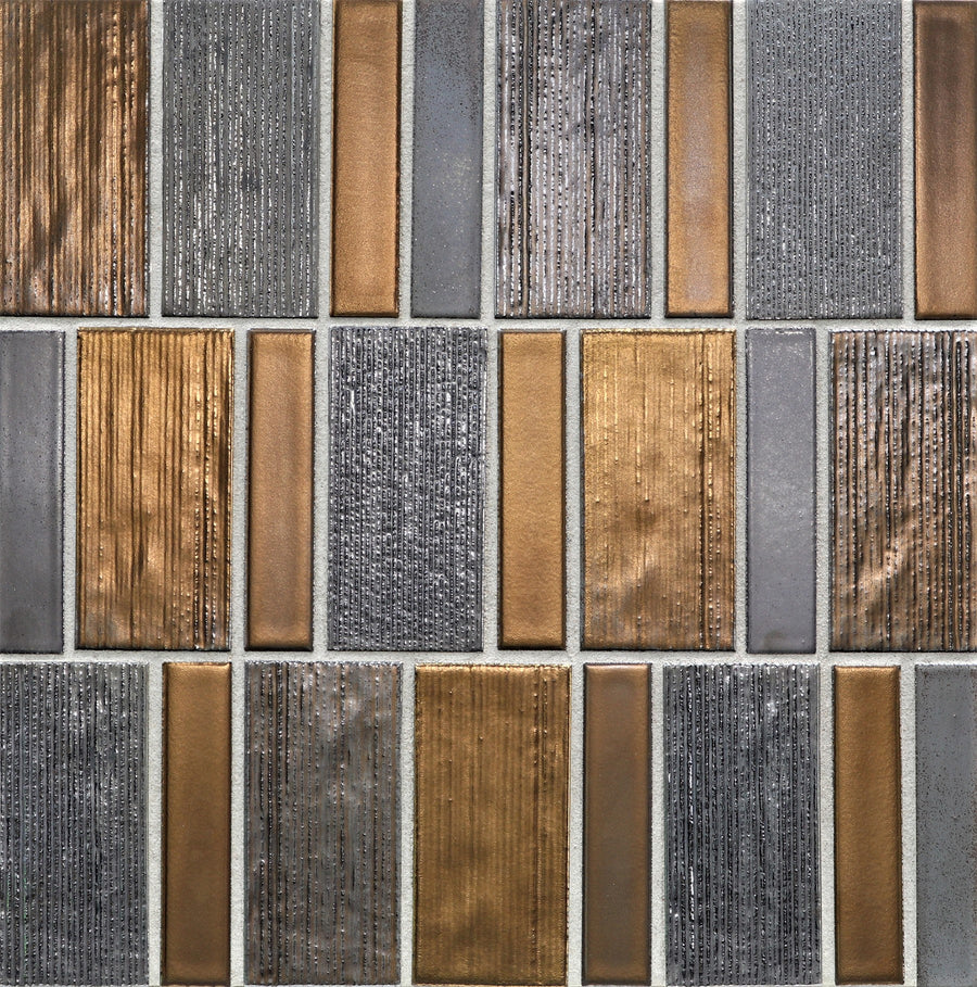 A close-up of Shinju Mosaic Tile in Swell Glazed, featuring rectangular tiles in metallic gold, bronze, and textured gray arranged geometrically—ideal for accent walls or a striking mosaic effect.