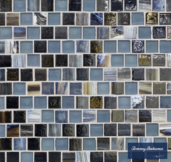 A mosaic tile pattern with small Aogashima Mix squares—shades of blue, gray, and black, some glossy—ideal for accent walls. The lower right corner displays the Tommy Bahama Offset Mosaic Tile logo.