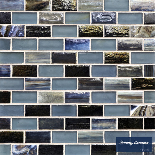 A close-up of Tommy Bahama 1 sf/sh Brick Ceramic Tile in the Aogashima Mix color, featuring rectangular tiles in blue, gray, and black shades arranged in a brick pattern.