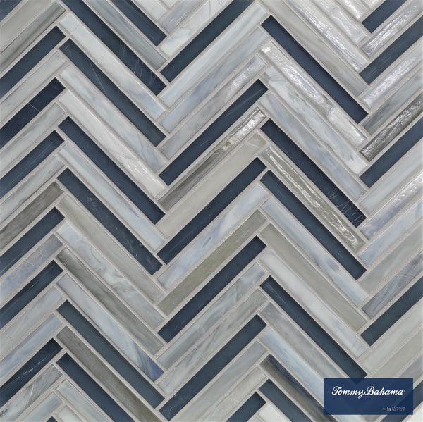 The Tommy Bahama Zig & Zag Mosaic Tile in Twillingate Mix features a chevron zig zag pattern in blue, gray, and white with a glossy finish. A small Tommy Bahama by Lunada Bay Tile logo is in the bottom right corner.