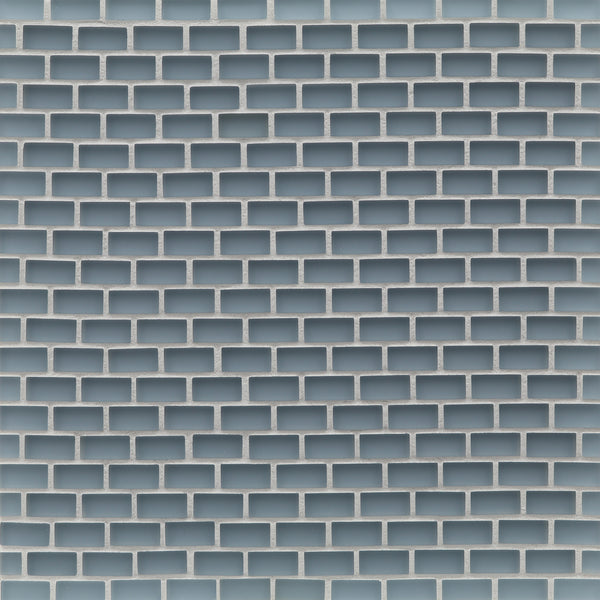 A close-up of a wall with a repeating rectangular brick pattern in light blue and white, resembling a geometric grid—perfect for backsplashes using Tomei Mini Brick Mosaic Tile in Silk.