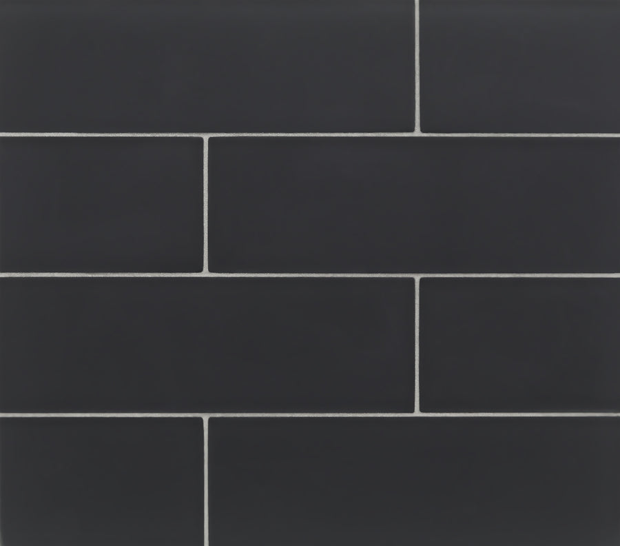 Tomei 3" x 9" Subway Tile in Silk features dark rectangular tiles with light grout, arranged in a staggered brick pattern—ideal for contemporary spaces or creating a stylish kitchen backsplash with classic subway tile appeal.