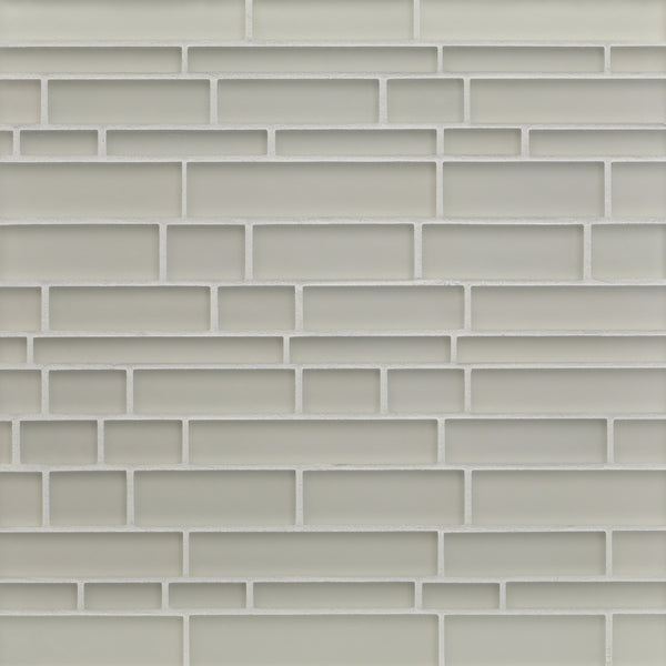 A close-up view of a wall with Tomei Falling Water Mosaic Tile in Silk, arranged in a staggered pattern with light gray ceramic tiles and white grout, creating a modern look.