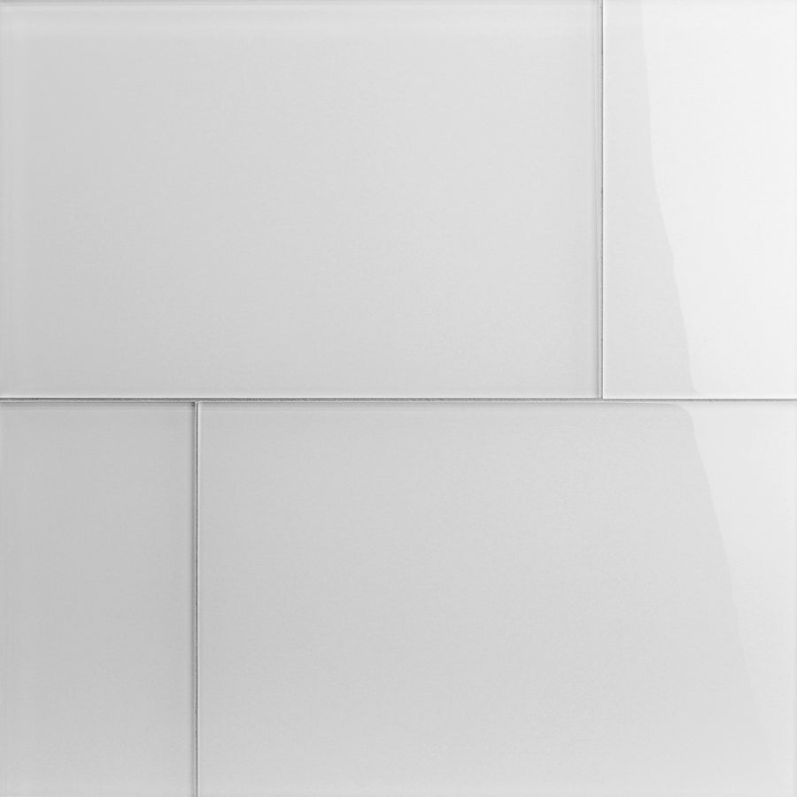 A close-up of Tomei Modeules 12" x 18" Ceramic Tile in Natural shows a white, glossy surface with a brick-like pattern. Clean grout lines and reflective finish add a modern touch to any contemporary space.