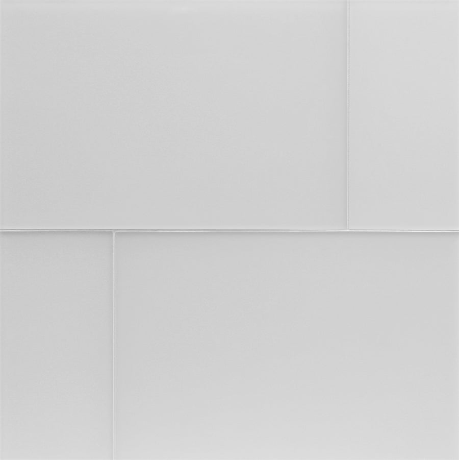 A close-up of Tomei Modeules 12" x 18" Ceramic Tile in Silk shows smooth, white tiles arranged in a staggered pattern with thin grout lines, creating a clean surface that reflects contemporary design and modern style.