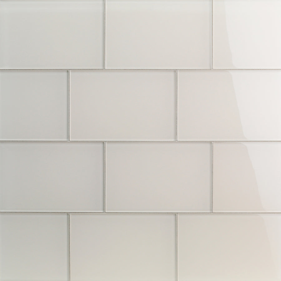 A close-up of a wall featuring Tomei Modules 6" x 9" Ceramic Tile in Natural. Arranged in a brick pattern, the glossy finish reflects light, adding shine and a contemporary feel to modern interiors.